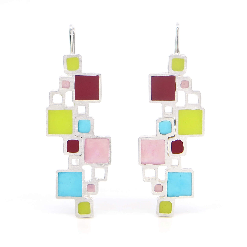Sterling open squares earrings with an architectural look. Some squares filled with pigmented resin, others open space. Apple green, teal, blue, and turquoise make for vibrant, Mondrian-like earrings.