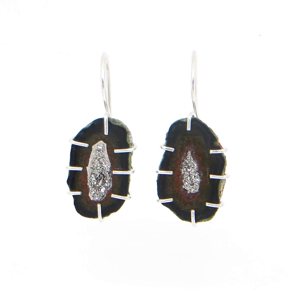 Mini split oval geodes with black, dark red, and speckle green outline.  Platinum coated interior crystals. Sterling cage prong settings with attached dangle ear wires.