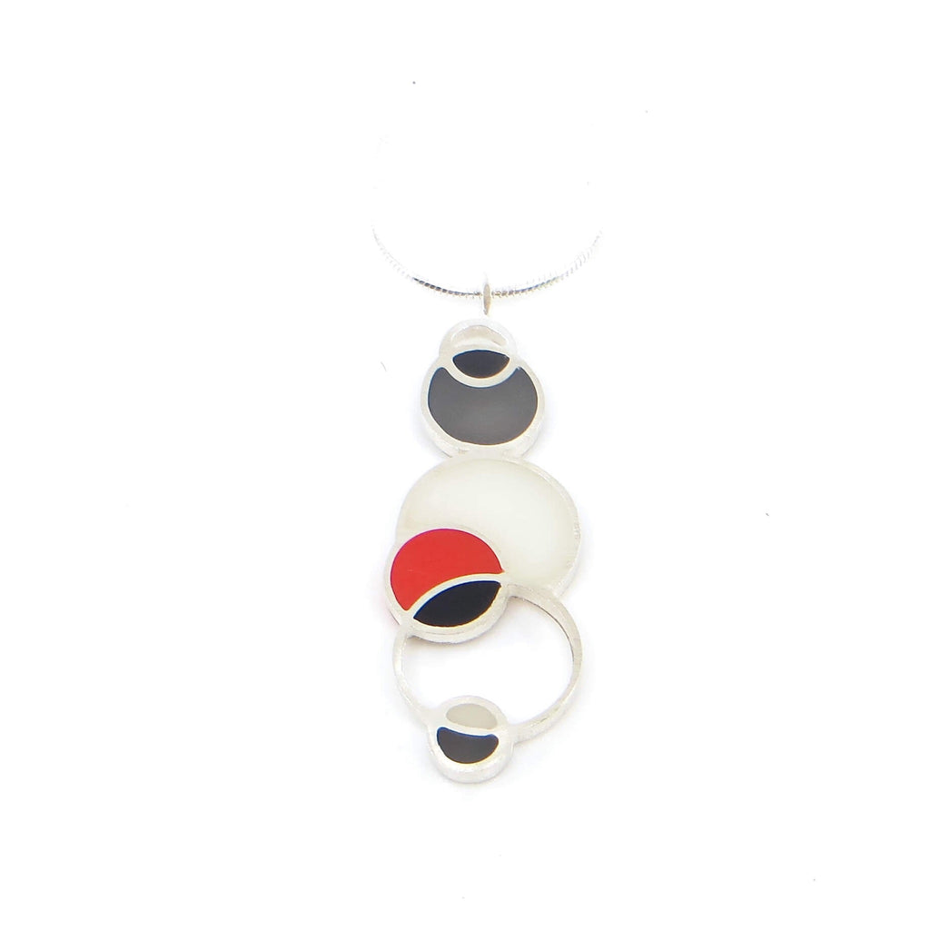 Sterling silver and pigmented resin open circles geometric pendant. Red, Black, White, and Grey "Woodpecker" Colors. Pendant is 1.5" and sterling snake chain is 16". Geometric.