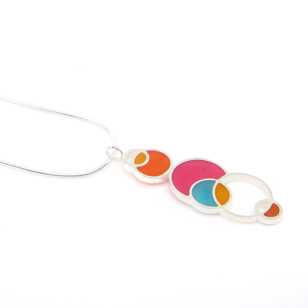 Sterling silver and pigmented resin open circles geometric pendant. Pink. Orange. Dark orange. Aqua. "Summer" Colors. Pendant is 1.5" and sterling snake chain is 16". Geometric.