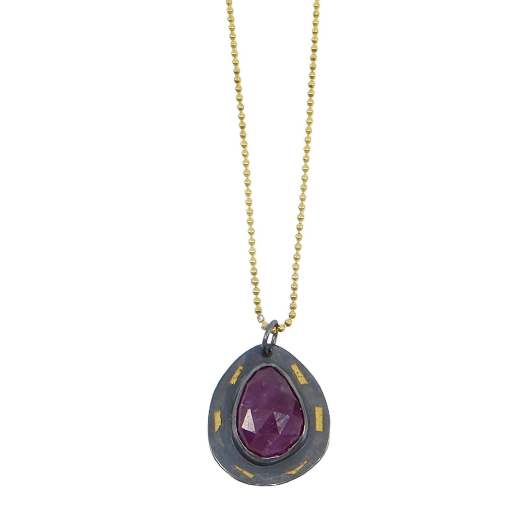 Pear shape rose cut ruby set on kaum-boo pear shaped border. 24k gold pieces on black patinated sterling. 16" gold bead chain.