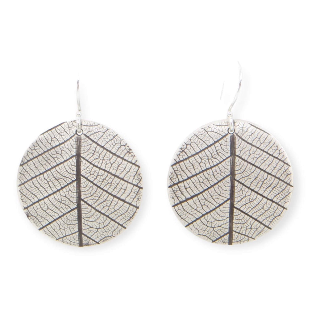 Slightly curved silver discs with leaf and veining pattern that resembles peas sign. Sterling silver ear wires. Dangle earrings. Leaves of Peace.