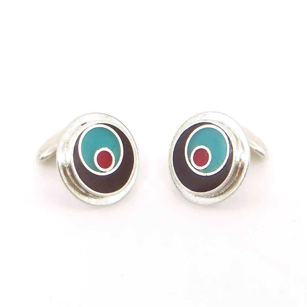 Sterling silver cufflinks with brown, turquoise, and red resin inlay.  Off target concentric circles.