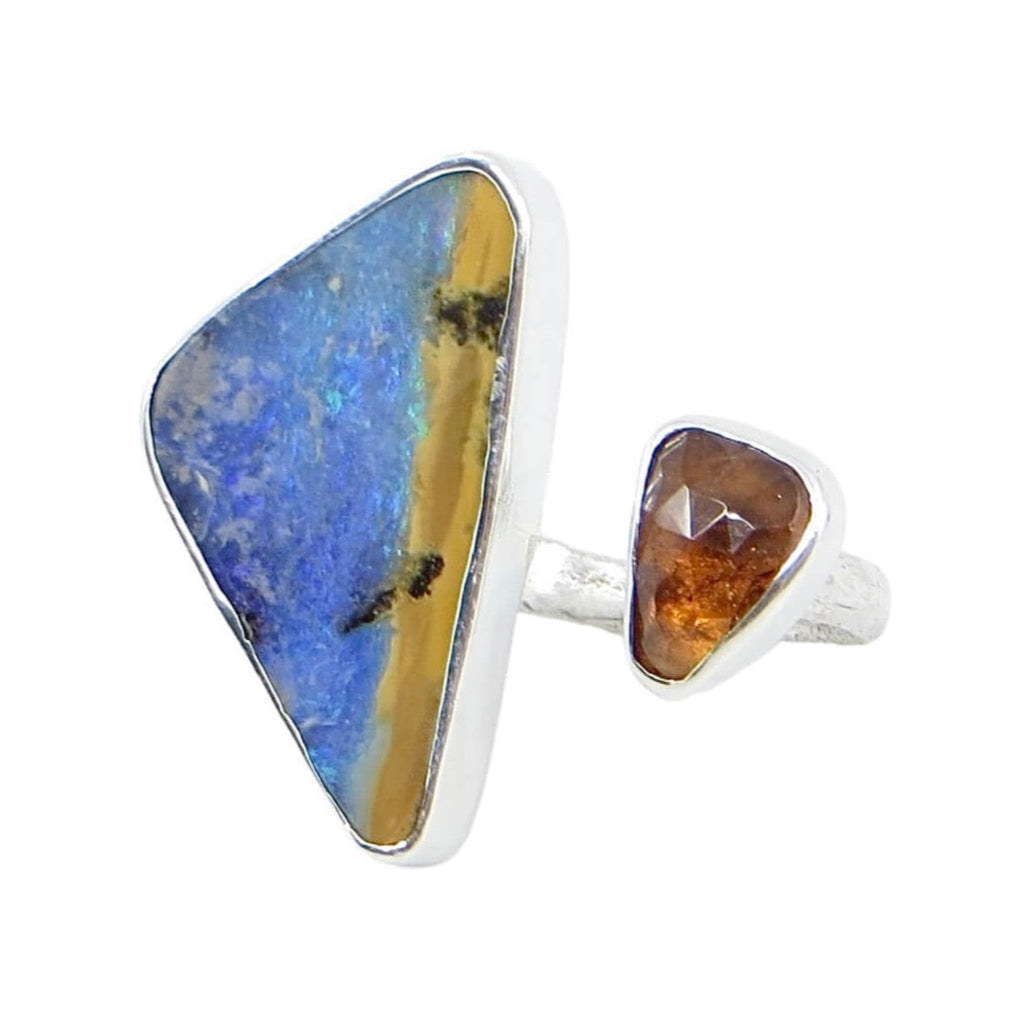 Open top ring. Big triangular blue and maize boulder opal with smaller rose cut triangular hessonite garnet. Sand cast sterling silver band. Fits US sizes 5.5-6.5. Looks like the colors of a beach and a golden sunset.