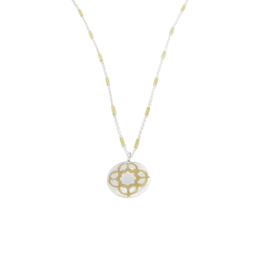 Sterling silver and 18k gold embellished flower geometric patterned disc pendant. Hangs from sterling silver and 14k gold filled  chain. 16"