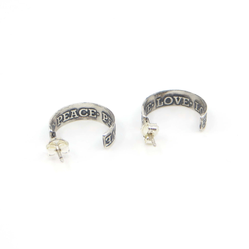Peace and Love post  3/4 hoop earrings. Etched with raised lettering on inside and outside of the sterling silver hoops. Earrings are opposites. Black patina in recesses to highlight the words.