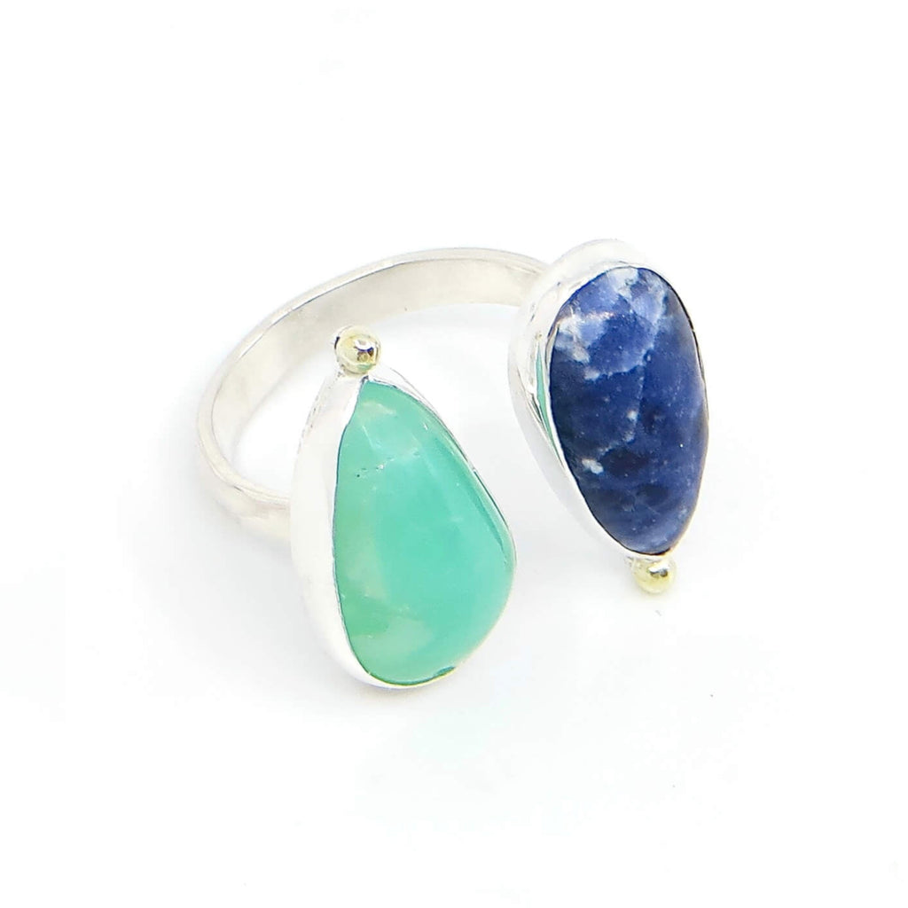Vivid green pear shaped cabochon chrysoprase and marbled dark blue pear shaped cabochon sodalite sit atop a sterling silver comfort band. A14k  gold ball is at the tip of each stone. Open top adjustable ring. US size 8 adjustable up or down 1/2 a size.