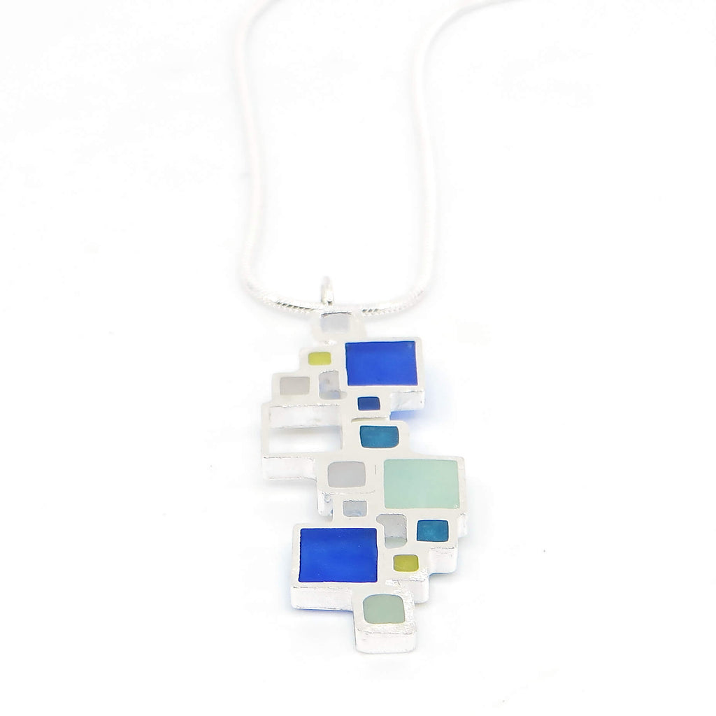 Sterling silver open squares with pigmented resin inlay in some of them . Blue. Teal. Seafoam green. Apple green. Sterling snake chain. Pendant 1.5" long. 16" chain.