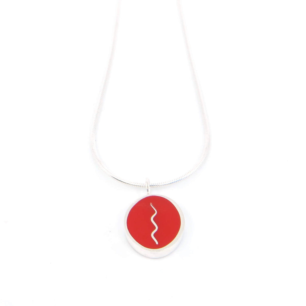 Sterling silver oval pendant with vertical center squiggle. Red.