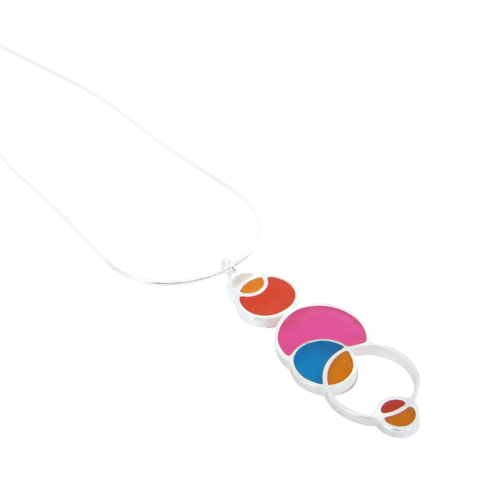 Open circles pendant. Sterling silver and pigmented resin. Sterling 16" snake chain. Pink, dark orange, orange, aqua. Matte finish one side, shiny other side.