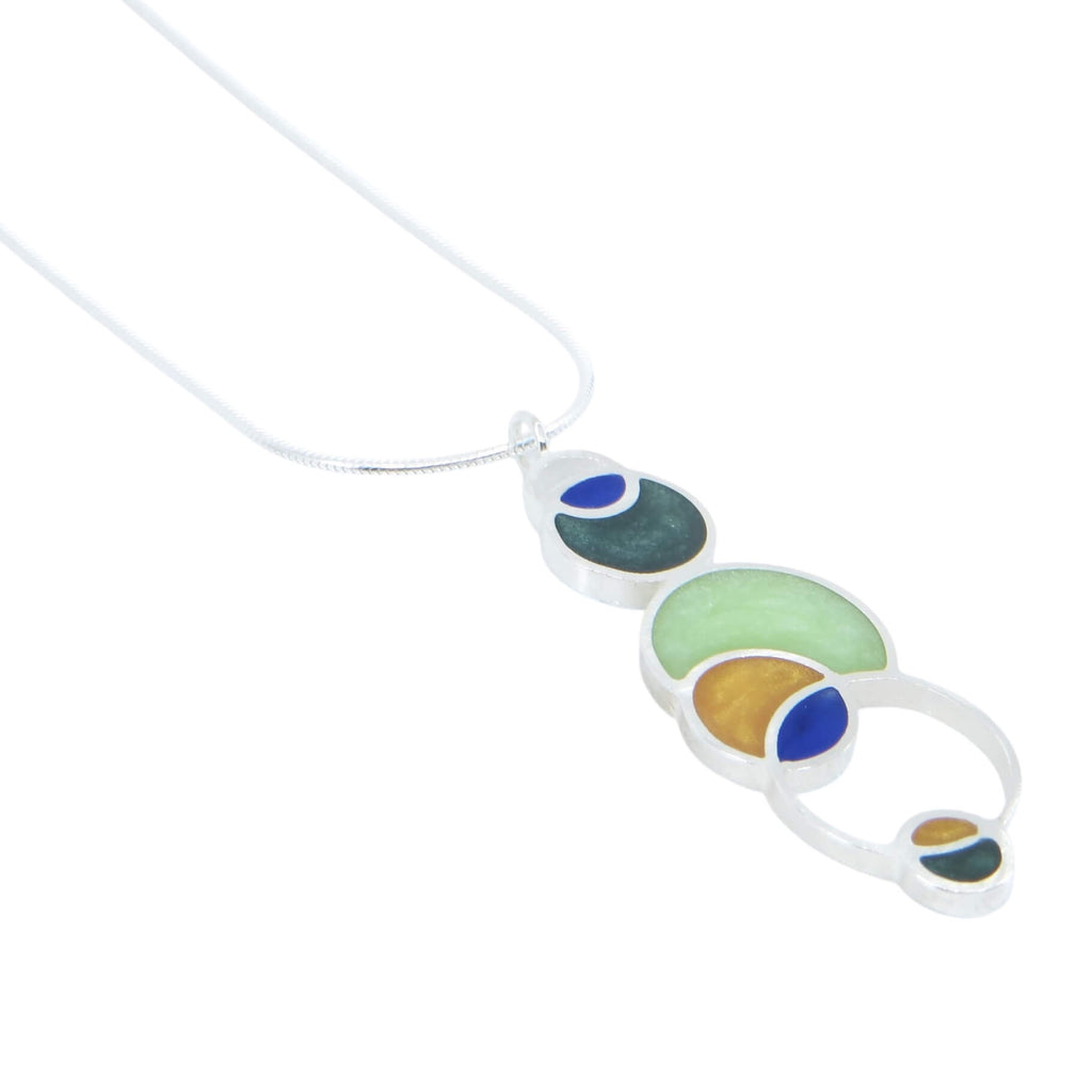 Open circles pendant. Sterling silver and pigmented resin. Sterling 16" snake chain. Blue, dark green, light green, maize.. Matte finish one side, shiny other side.