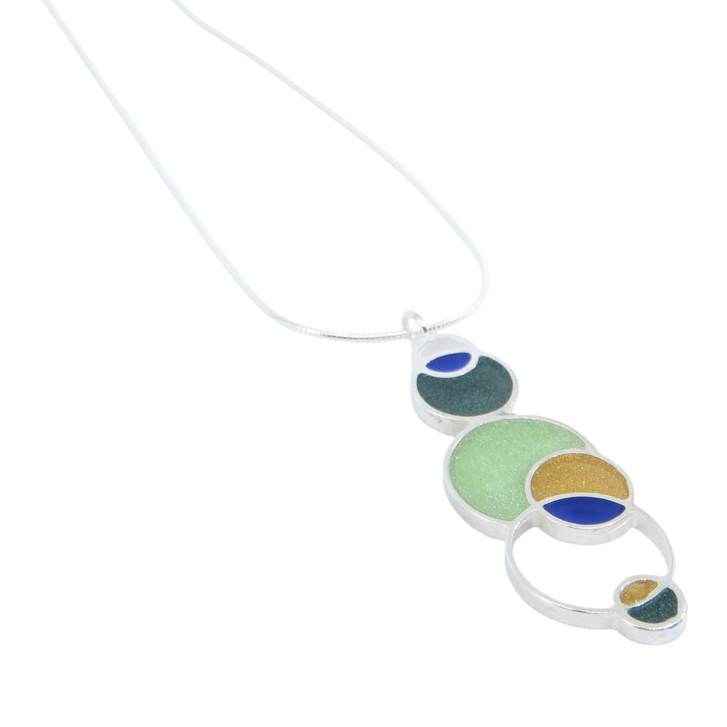 Open circles pendant. Sterling silver and pigmented resin. Sterling 16" snake chain. Blue, dark green, light green, maize.. Matte finish one side, shiny other side.