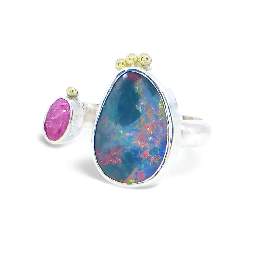 Open top boulder opal and pink oval faced tourmaline ring. 3 18k royal yellow gold balls at top of opal setting. 1 18k royal yellow gold ball on top of tourmaline setting. Crown look. Sterling silver 1/2 round band. Bezel set stones. US size 6.25 adjustable up or down a quarter size.