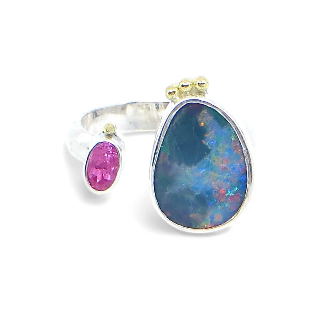 Open top boulder opal and pink oval faced tourmaline ring. 3 18k royal yellow gold balls at top of opal setting. 1 18k royal yellow gold ball on top of tourmaline setting. Crown look. Sterling silver 1/2 round band. Bezel set stones. US size 6.25 adjustable up or down a quarter size.