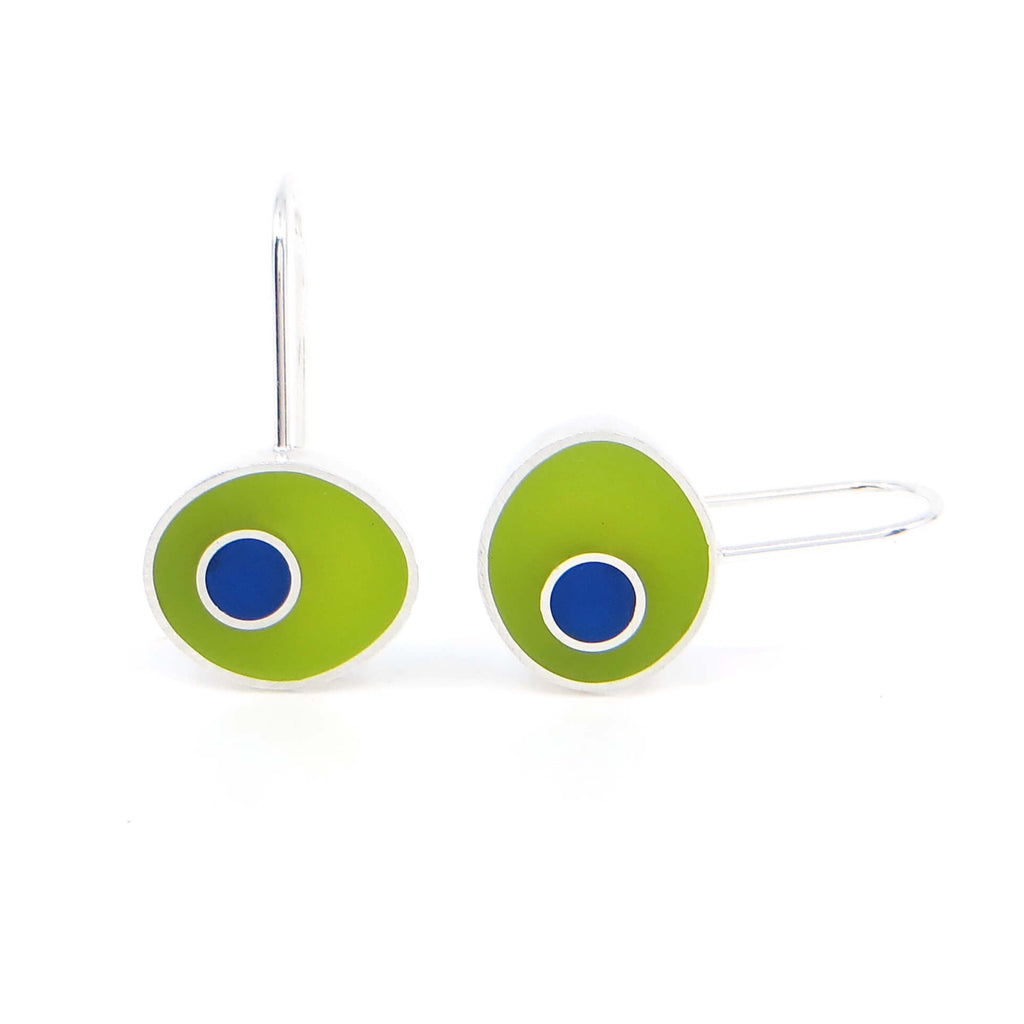 Sterling silver horizontal oval earrings filled with pigmented resin inlay.  Apple green with blue dots surrounded by silver border.  Dots  are off center so they look like side eyes.