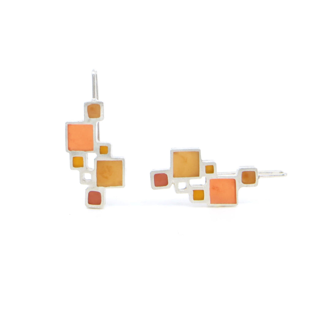 Sterling open squares earrings with square hooked earlier have pigmented resin inlay in some squares. Pumpkin orange, brick red, and golden make lovely autumn colored earrings. Mondrian-like.
