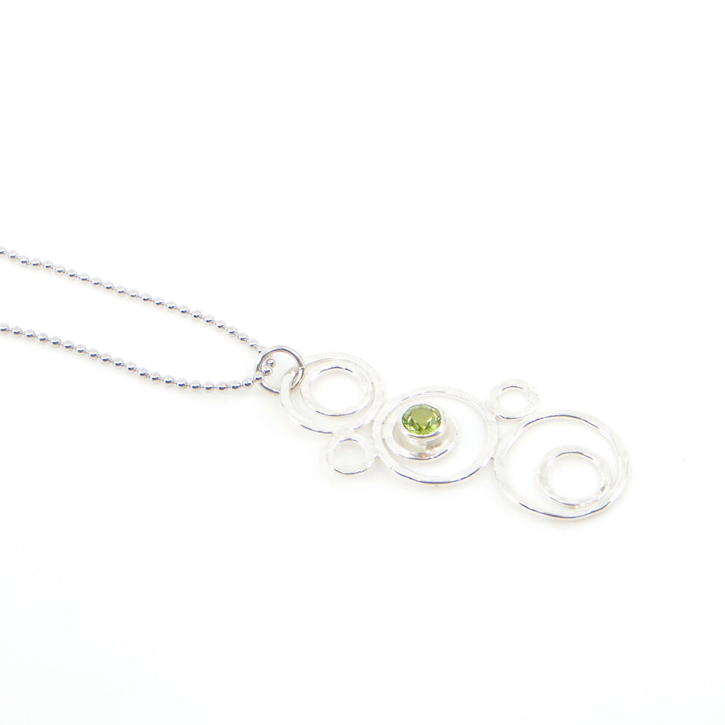 Hammered argentium silver circles-bubbles-of different sizes pendant with 3.5 mm tube set peridot. Bubblescence necklace. Sterling bead chain.