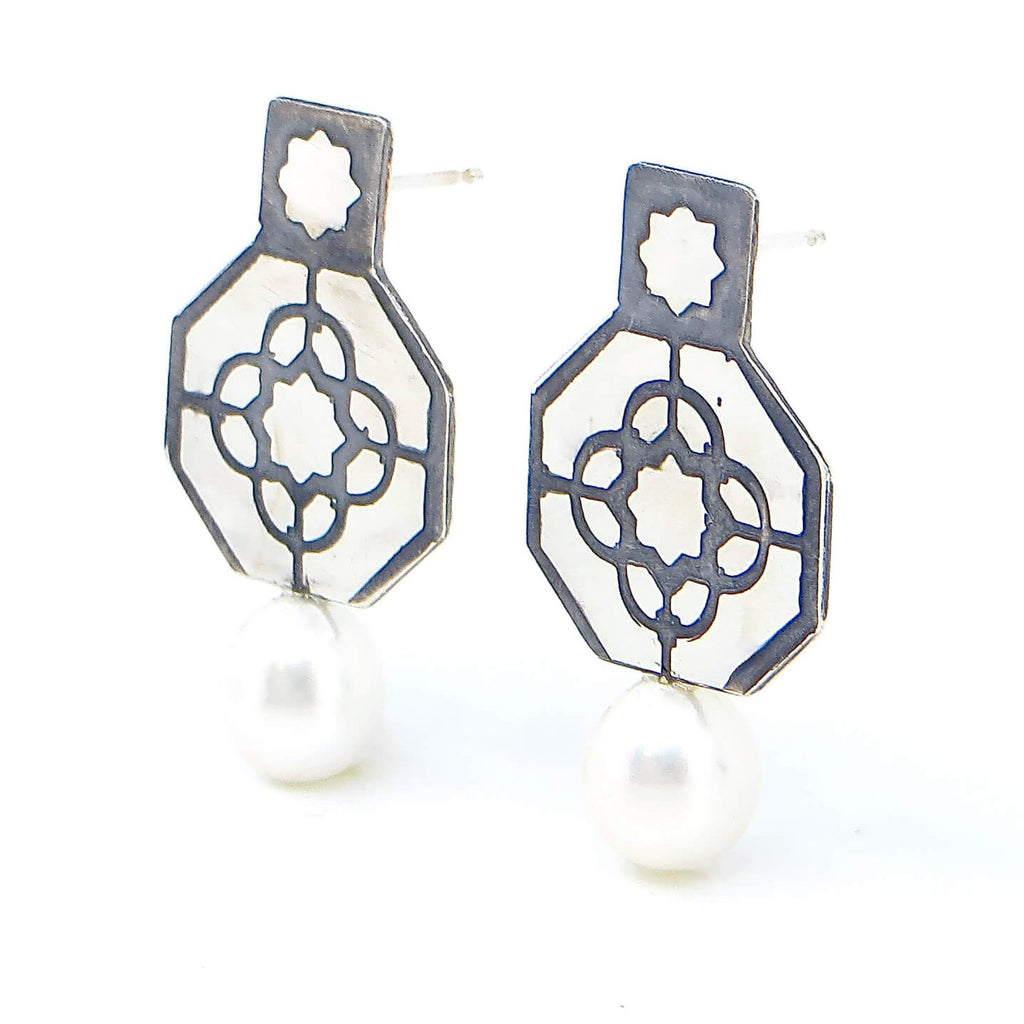 Etched sterling and pearl post earrings. Octagonal silver with top square and etched geometric pattern in octagon with 8 point star etched in top square. Black patina in recesses to highlight pattern. A lustrous white 8mm pearl drop adds a touch of elegance. Edgy. Fine. Contemporary. Elegant.