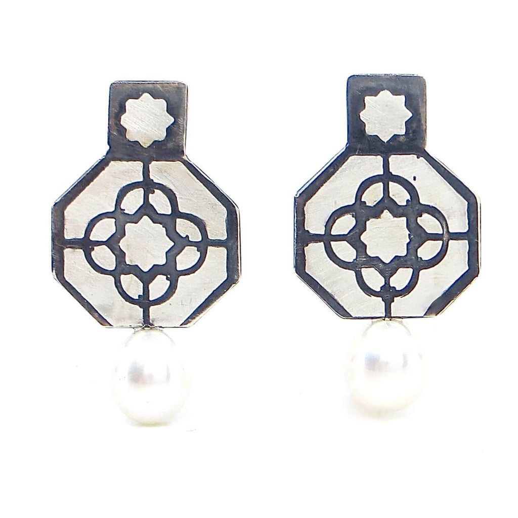 Etched sterling and pearl post earrings. Octagonal silver with top square and etched geometric pattern in octagon with 8 point star etched in top square. Black patina in recesses to highlight pattern. A lustrous white 8mm pearl drop adds a touch of elegance. Edgy. Fine. Contemporary. Elegant.