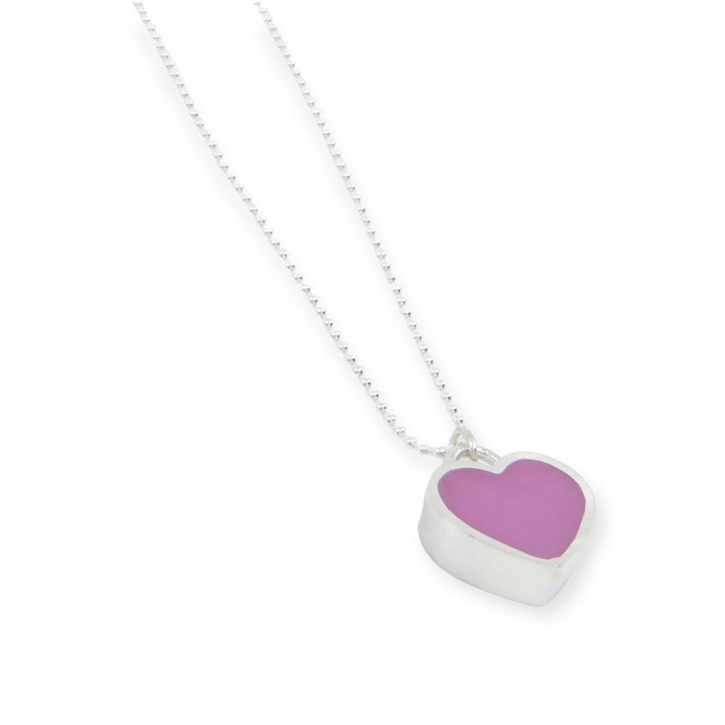 A "candy" heart pendant. A sterling silver heart frames richly colored pigmented resin to form a chunky little candy heart that hangs from a sterling silver bead chain. Heart is .5" Choice of 16" or 18" chain. Magenta