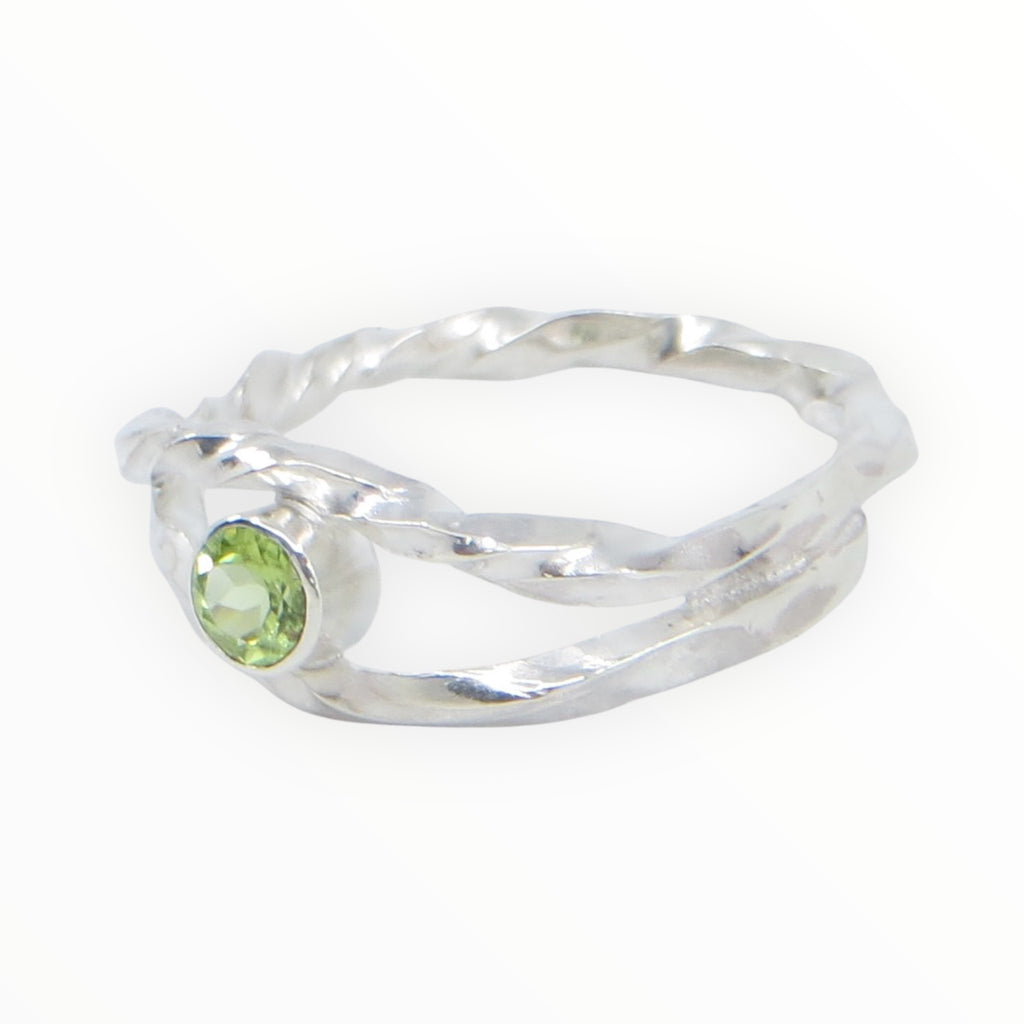Twisted square wire sterling silver ring with the band creating an open marquis shape that hugs a tube set peridot in the center. 4mm round peridot. US Size 8. 