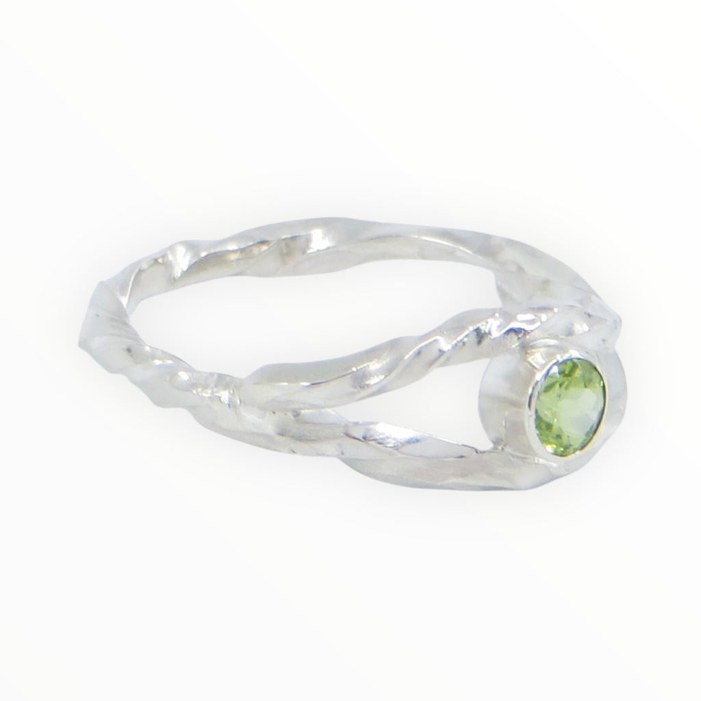Twisted square wire sterling silver ring with the band creating an open marquis shape that hugs a tube set peridot in the center. 4mm round peridot. US Size 8. 
