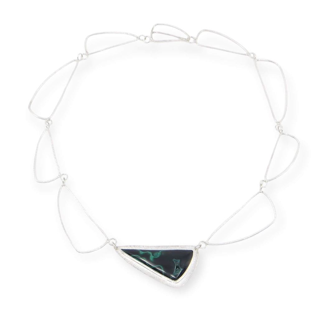 Curved triangle malachite pendant bezel set on chisel textured backing. Chisel textured complementary sterling silver links form the necklace that features the malachite front and center. The clasp is fabricated to match the triangular links. 17"