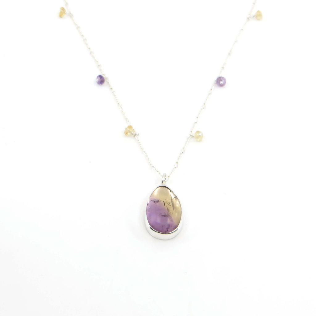 Teardrop ametrine pendant suspended from 16" sterling  chain with tiny faceted amethysts and citrine beads spaced along the chain.