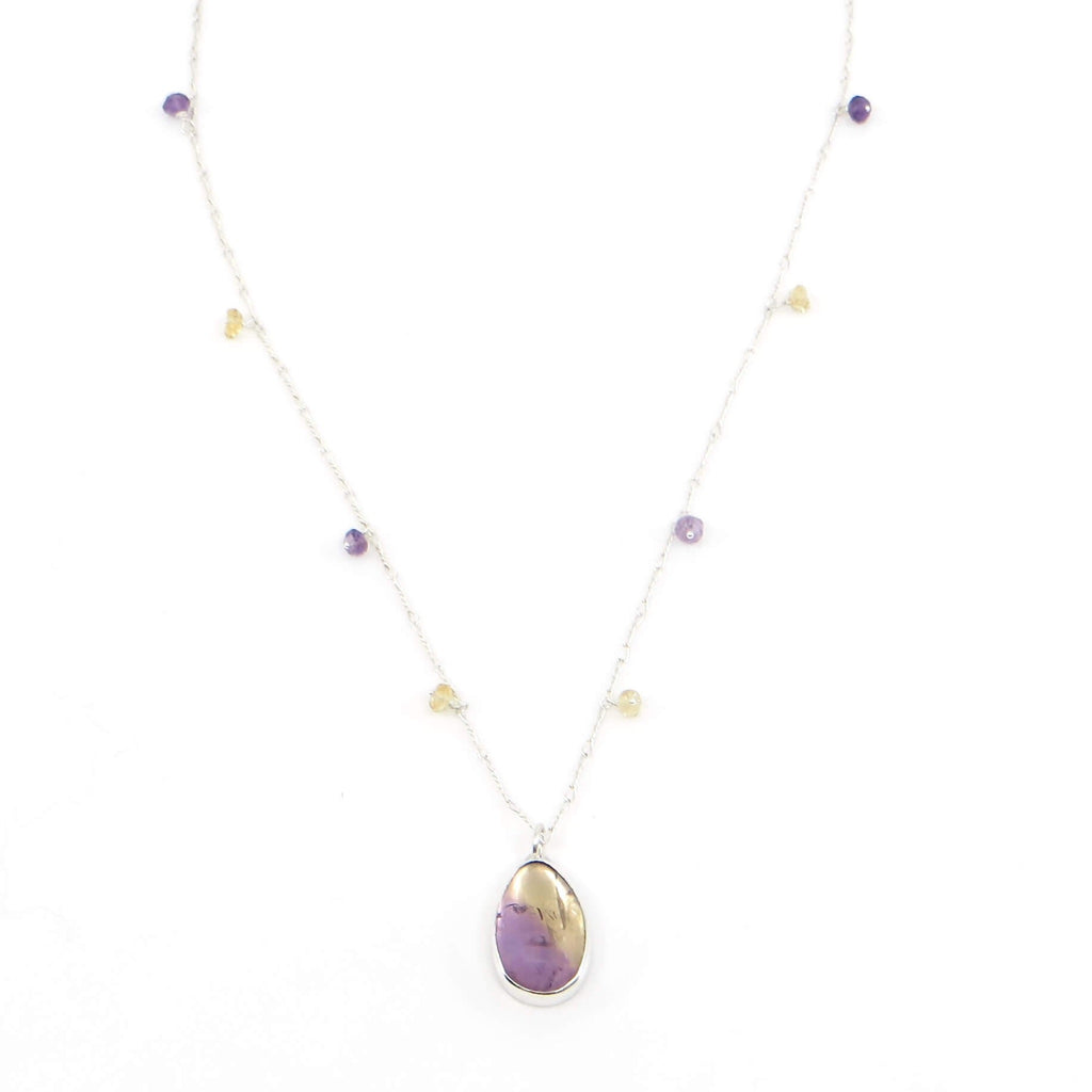 Teardrop ametrine pendant suspended from 16" sterling chain with tiny faceted amethysts and citrine beads spaced along the chain.