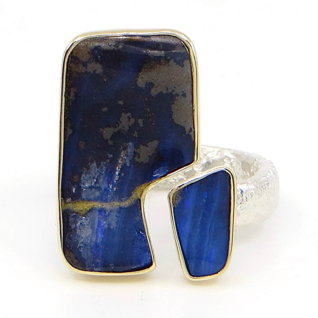 Two pieces of vivid blue boulder opal  set in 14k gold bezels. Open top style ring. Sterling sand cast band. Stone pieces  fit together like tectonic plates with a space. Fits US Size 7.25-7.5