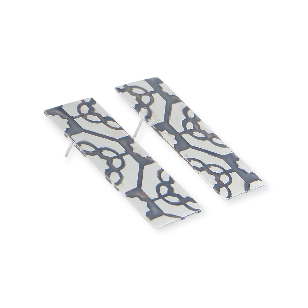 Etched rectangle sterling silver post earrings. Geometric pattern with black patina to highlight the pattern and provide a nice contrast to the silver. Edgy. Fine. Contemporary. Great with casual and dressy attire.