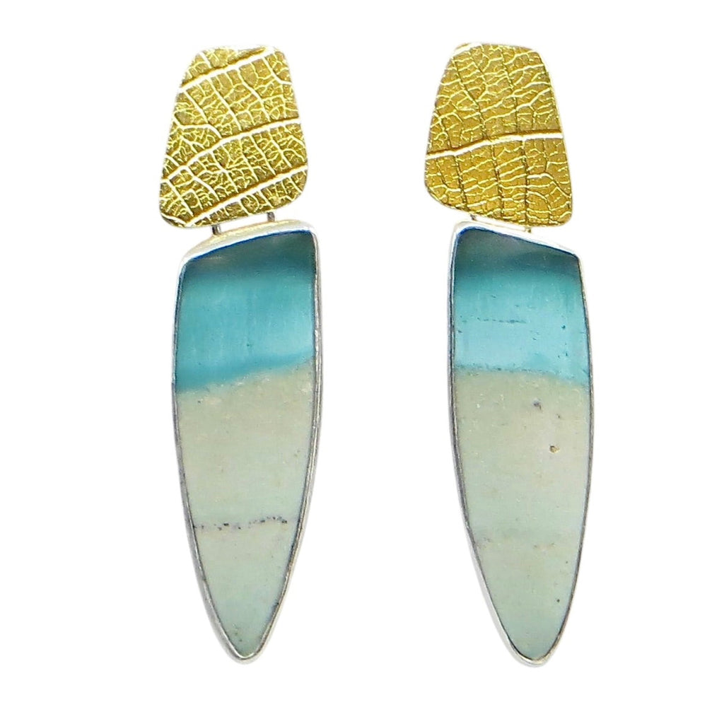 Earrings. Turquoise and beige colored stones that are opalized petrified wood suspended from leaf imprinted 24k gold over silver components.