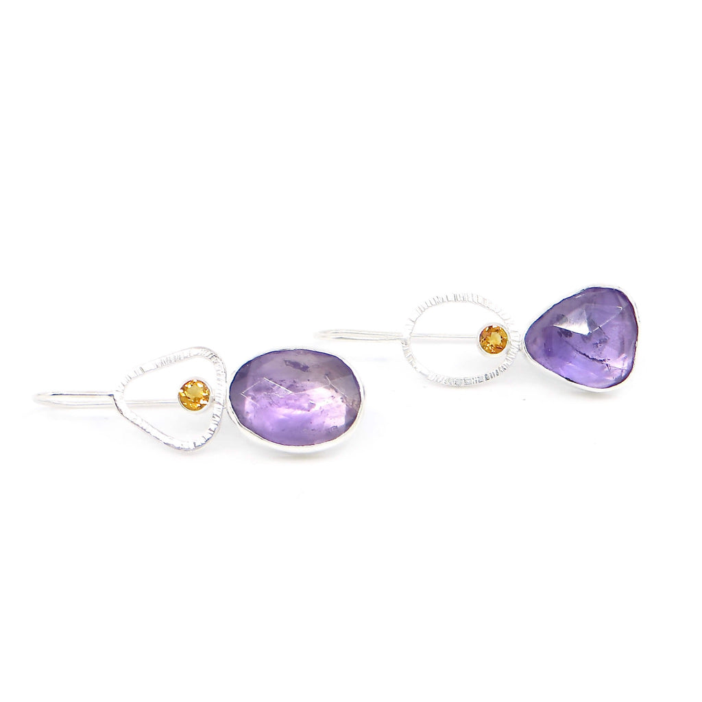 Oval and triangle rose cut amethyst and round faceted citrine earrings. Citrines sit in oval and triangle textured sterling frames so earrings have complementary shapes. Sterling ear wires. Dangle earrings.