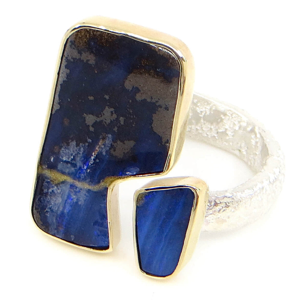 Two pieces of vivid blue boulder opal set in 14k gold bezels. Open top style ring. Sterling sand cast band. Stone pieces fit together like tectonic plates with a space. Fits US Size 7.25-7.5