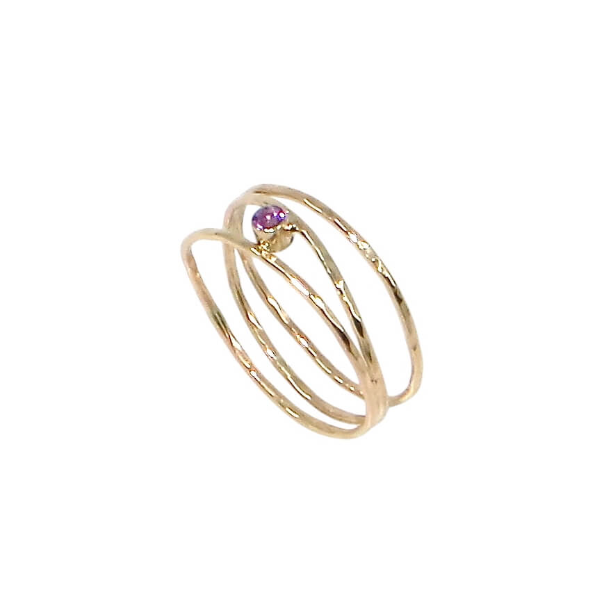 3 hammered 14k gold bands are attached at different points that make it look like an airy set of stacking rings. A tube set amethyst is hugged between to of the bands to add a lovely purple sparkle. US size 5.5.