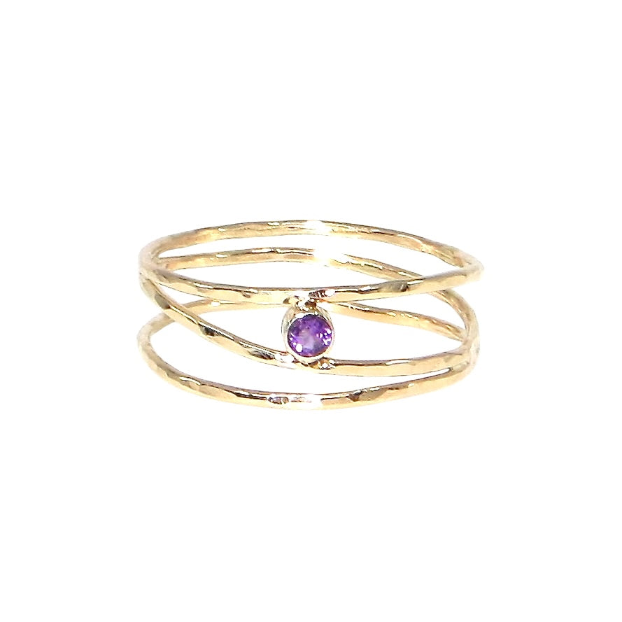 3 hammered 14k gold bands are attached at different points that make it look like an airy set of stacking rings. A tube set amethyst is hugged between to of the bands to add a lovely purple sparkle. US size 5.5.