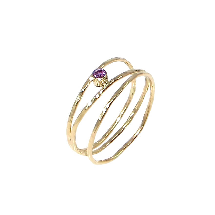 3 hammered 14k gold bands are attached at different points that make it look like an airy set of stacking rings. A tube set amethyst is hugged between to of the bands to add a lovely purple sparkle. US size 5.5.