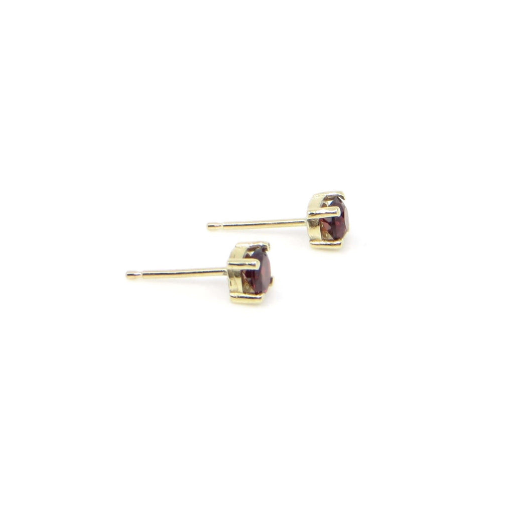 14k gold and round garnet contemporary classic 4 prong set stud earrings.