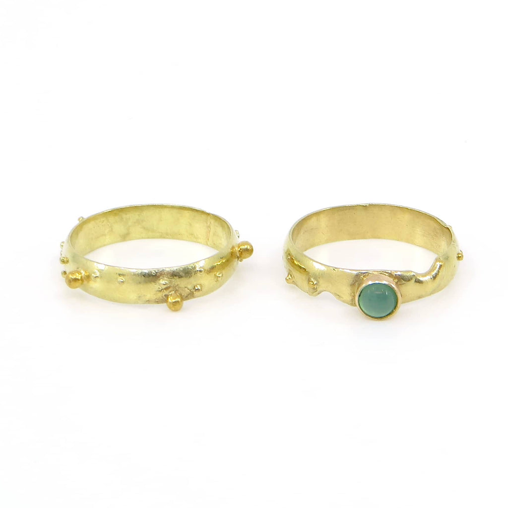 18k yellow gold ring set. Various sized gold balls scattered around bands. One band has a 14k set green chrysoprase. Contemporary granulation.