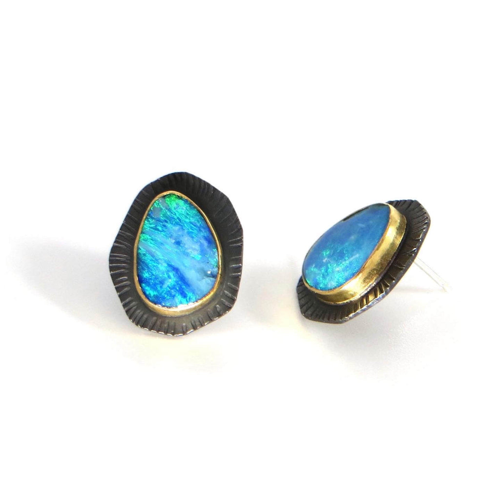 Bright aqua blue opals set in 14k bezels on top of blackened textured geometric angled sterling backplates.  Stud earrings.