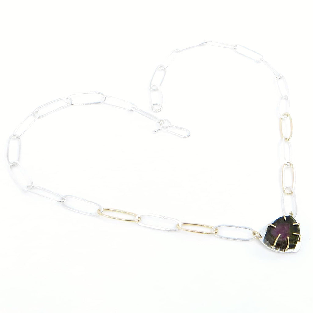 Watermelon tourmaline slice necklace. Set in 14k 6 prongs  on flat silver back triangular shield shape.  Paperlcip chain of 14k and argentium silver.