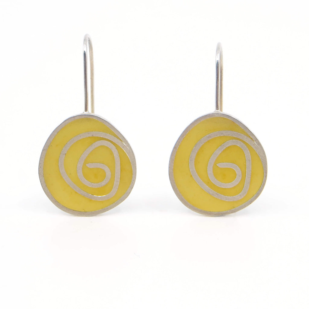 Sterling silver and yellow pigmented resin inlay swirl earrings.