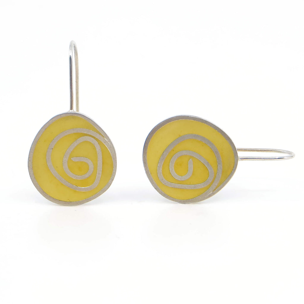 Sterling silver and yellow pigmented resin inlay swirl earrings.
